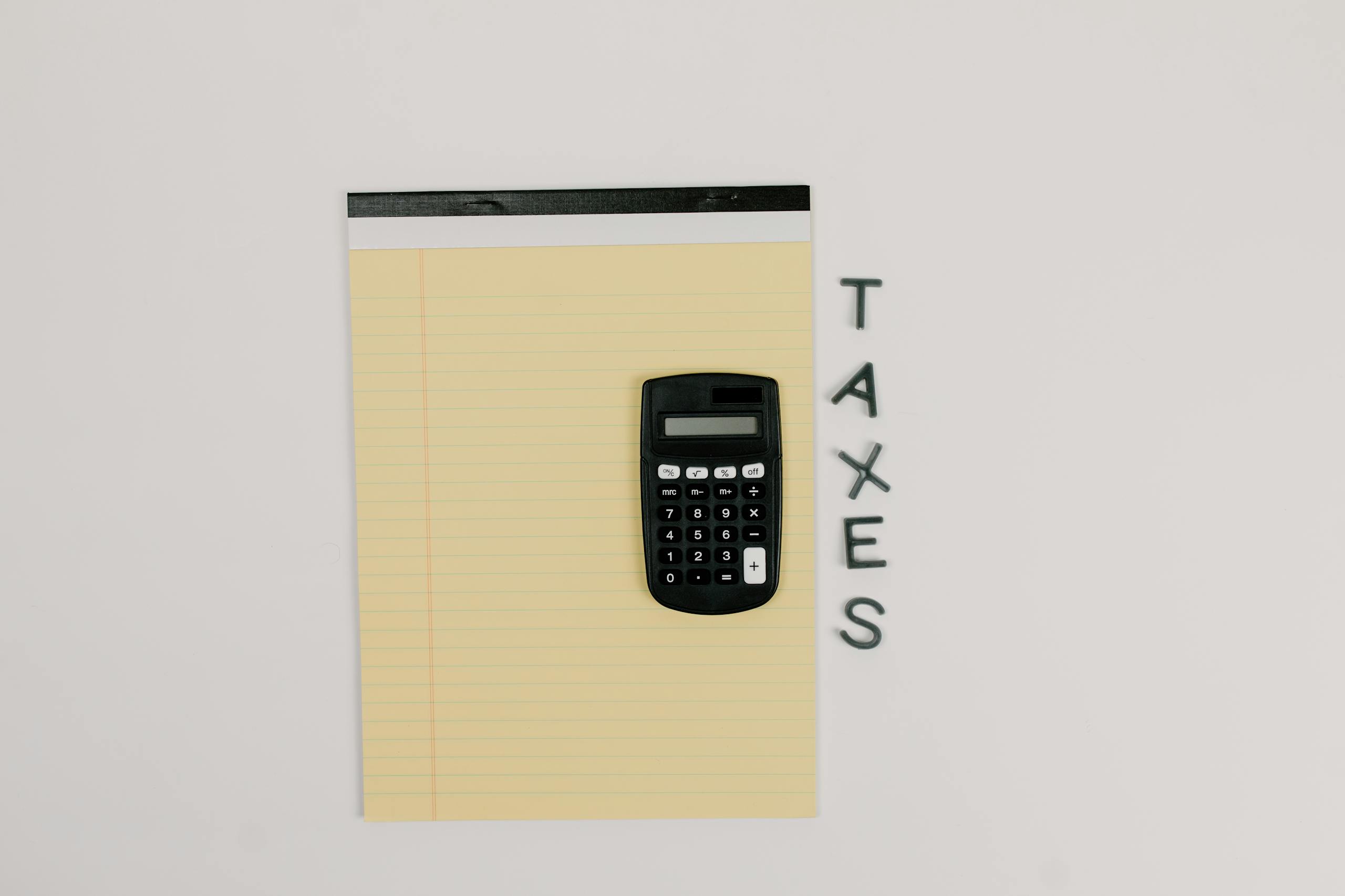 Calculator and notepad with 'TAXES'