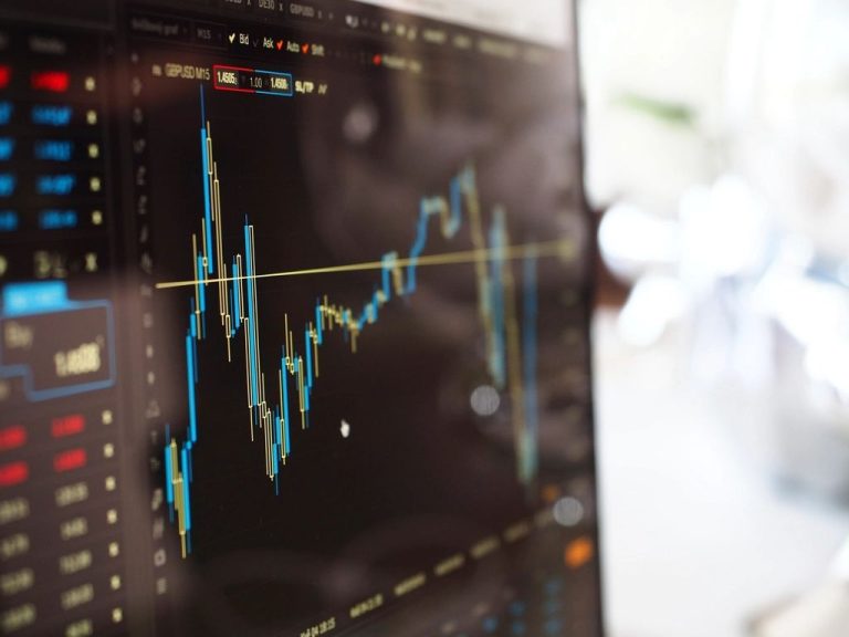 Stock market price chart on a screen, illustrating what is investing