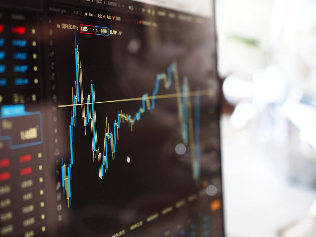 Stock market price chart on a screen, illustrating what is investing